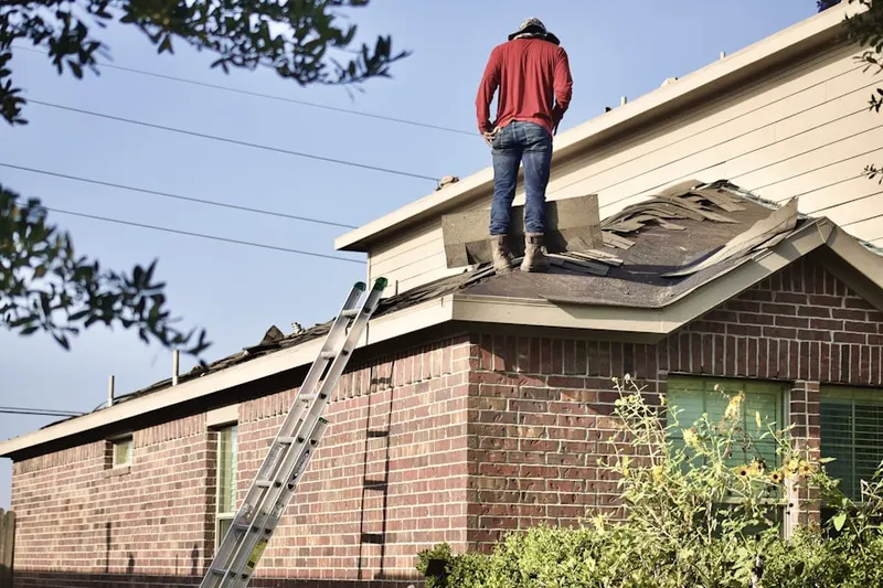 Professional roofer working on a residential roof in Neshanic